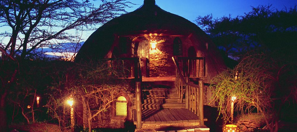 Room exterior by night at Serena Serengeti Safari Lodge, Serengeti National Park, Tanzania - Image 3