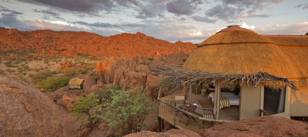 A suite with the bed and veranda overlooking the beautiful and unique landscape at Mowani Mountain Camp, Damaraland, Namibia - Image 1