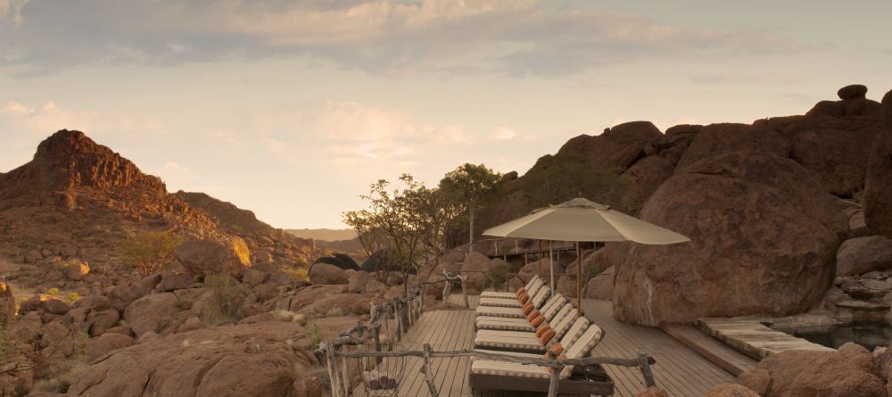 The veranda with pool and sunloungers at Mowani Mountain Camp, Damaraland, Namibia - Image 8