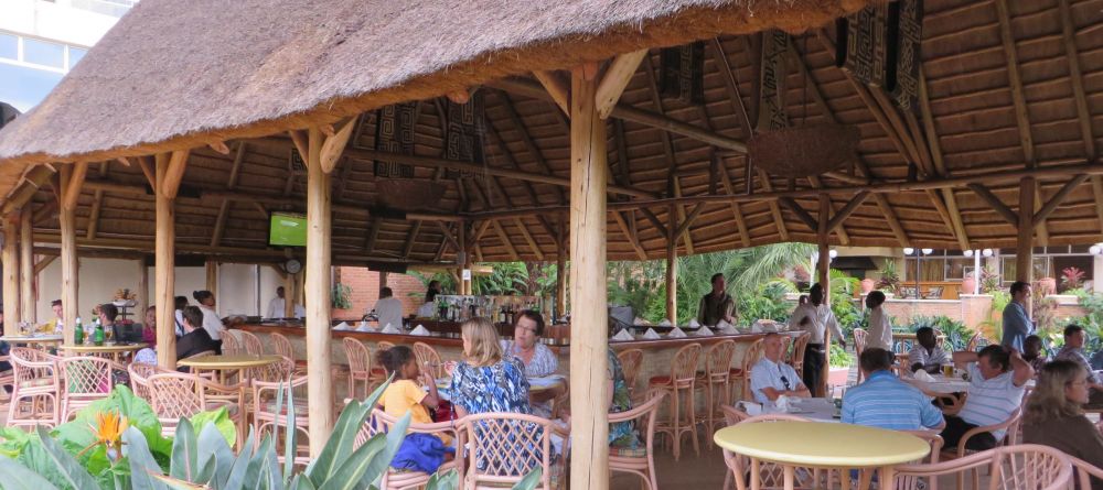 Enjoy a drank at the pool bar at Hotel des Mille Collines - Image 7