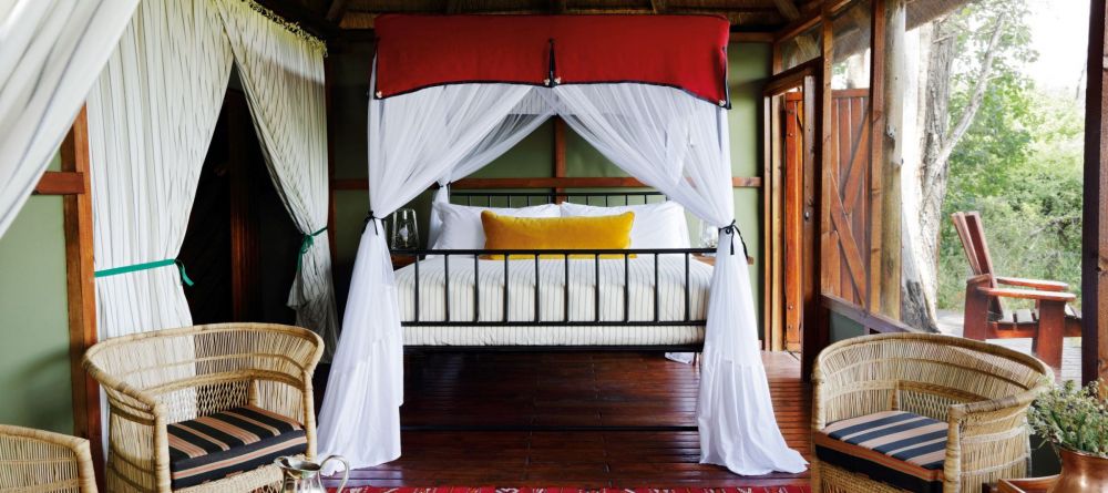 Mapula Lodge - double bed and seating area - Image 2