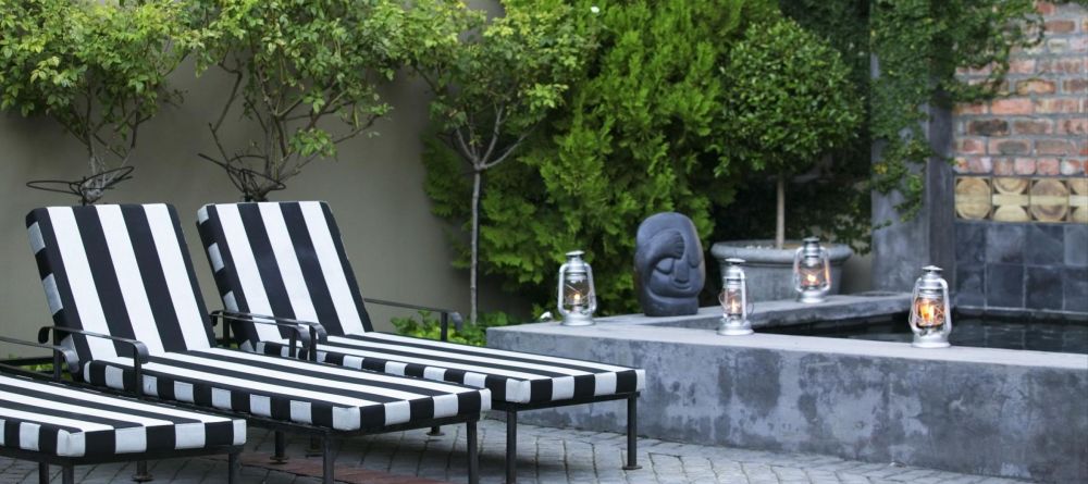 Sun loungers in the courtyard at Welgelegen Boutique Hotel, Cape Town, South Africa - Image 3
