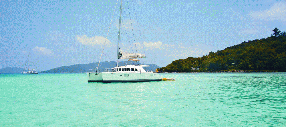 A sailboat just off the beach at New Emerald Cove, Praslin, Seychelles - Image 4