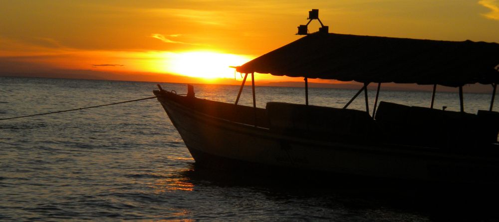 Boat silhouette at sunset at Gombe Forest Lodge, Gombe National Park, Tanzania - Image 2