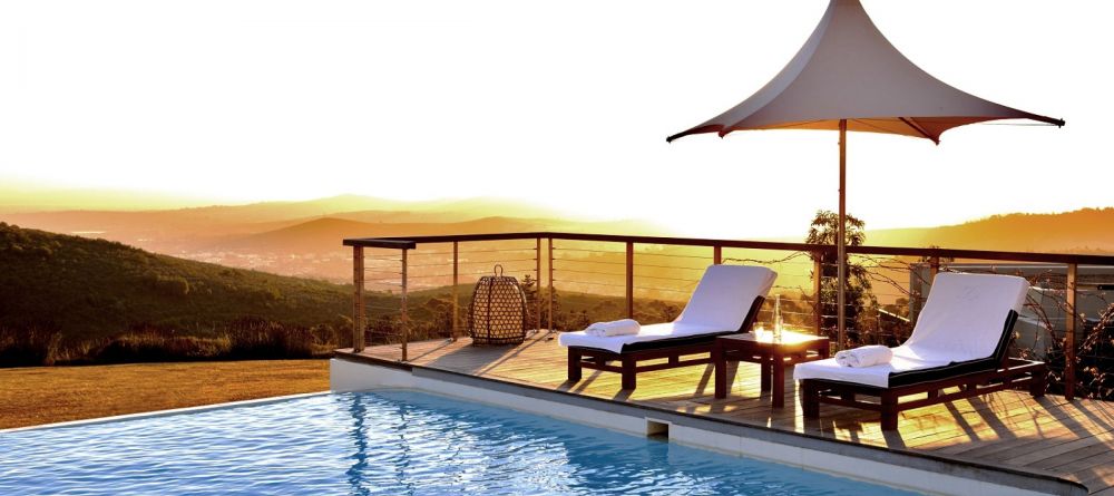 Watch the sunset over the valley from the pool at Delaire Graff, Stellenbosch, South Africa - Image 4