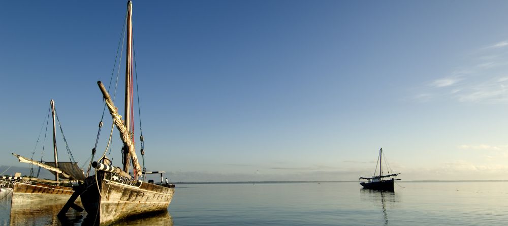 Dhow cruisers float in the serene waters at Pole Pole Bungalow Resort, Mafia Island, Tanzania - Image 2