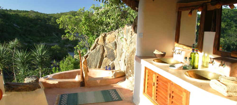 The open-air bathroom with a relaxing tub to enjoy the view at the Eagle Cottage at Sabuk Lodge, Laikipia, Kenya - Image 2