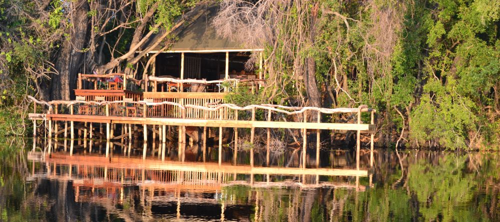 Camp exterior reflected on the water at Guma Lagoon Camp, Okavango Delta, Botswana - Image 2