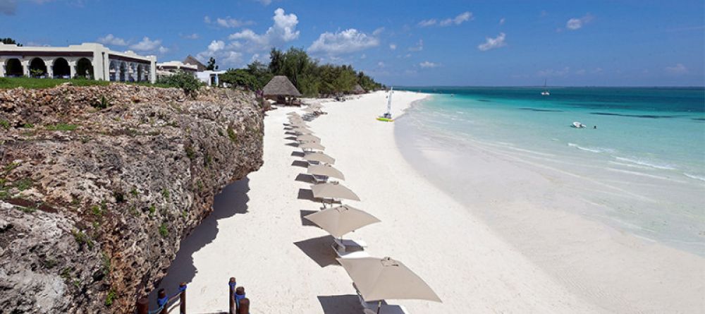 Rows of umbrellas and lounge chairs await guests along the spectacular beach at Hideaway of Nungwi Resort & Spa, Zanzibar, Tanzania - Image 10