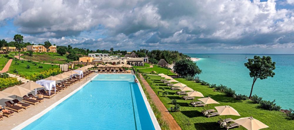Lounge in the sun by the beautiful pool at Hideaway of Nungwi Resort & Spa, Zanzibar, Tanzania - Image 8