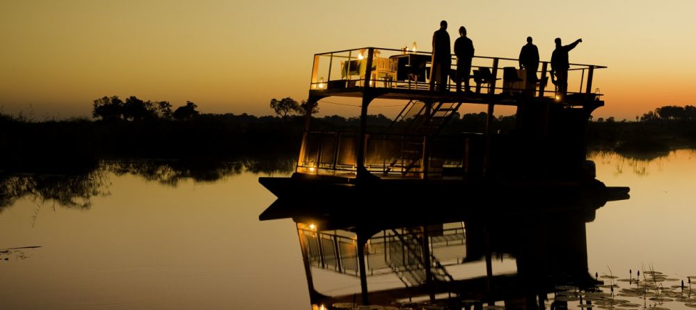 Boating at sunset at King's Pool Camp, Linyati Wetlands, Botswana (Dana Allen) - Image 1