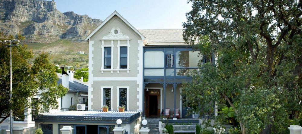 The charming facade set against the emerald mountain backdrop at Welgelegen Boutique Hotel, Cape Town, South Africa - Image 4