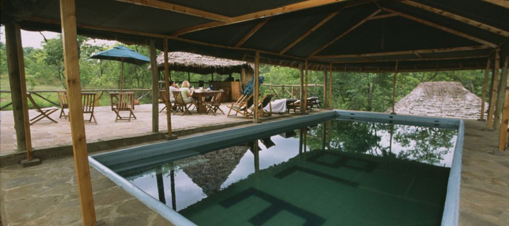Pool with dining area behind at Sable Mountain Lodge, Selous National Park, Tanzania - Image 7