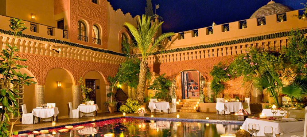 Poolside dining in the evening at Kasbah Tamadot, Atlas Mountains, Morocco - Image 7