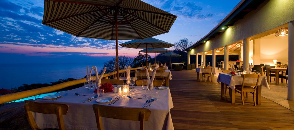 Outdoor dining in the evening at Pumulani, Lake Malawi, Malawi - Image 9