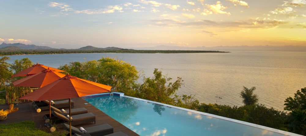 The sun sets over the pool at Pumulani, Lake Malawi, Malawi - Image 11