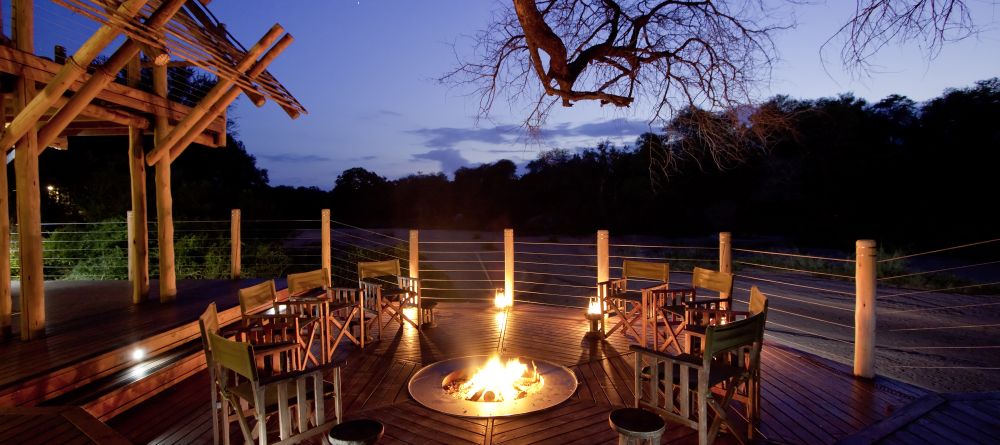 Rhino Post Safari Lodge - Deck in the Evening - Image 9