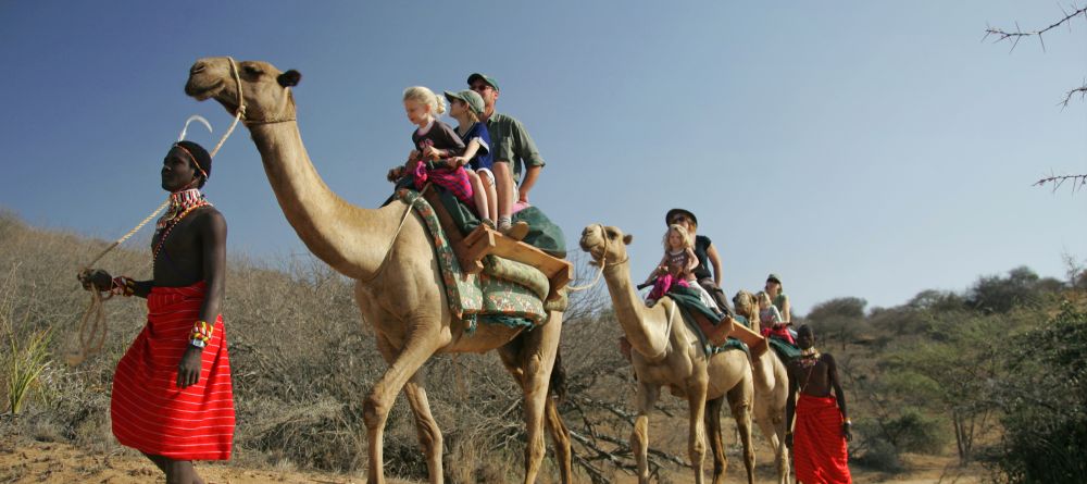 Families enjoying the camel-back safari ride at Sabuk Lodge, Laikipia, Kenya - Image 16