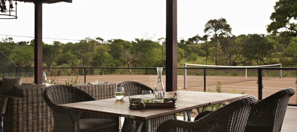 Tennis courts and outdoor dining allows guests to enjoy nature from the comfort of Singita Serengeti House, Serengeti Grumeti Reserves, Tanzania - Image 8