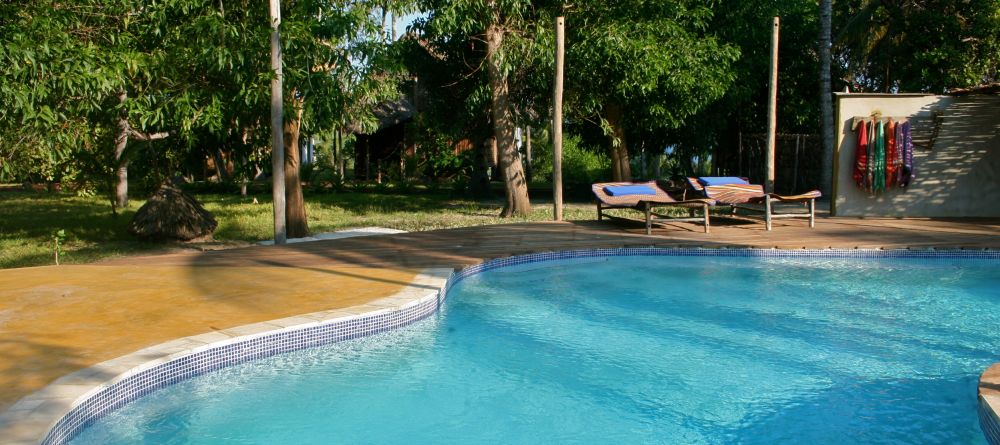 Soak up sun by the pool at Pole Pole Bungalow Resort, Mafia Island, Tanzania - Image 17