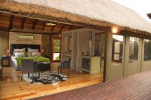 The bedroom opens up onto a private balcony at Shamwari Bayethe Tented Lodge, Shamwari Game Reserve, South Africa