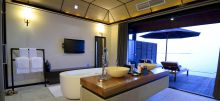 Bathroom with access to an open-air private balcony at Kuredu Island Resort, Lhaviyani Atoll, Maldives