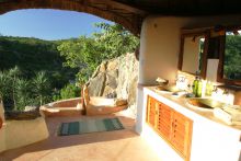 The open-air bathroom with a relaxing tub to enjoy the view at the Eagle Cottage at Sabuk Lodge, Laikipia, Kenya