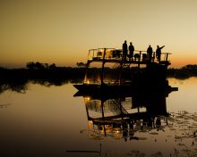 Boating at sunset at King's Pool Camp, Linyati Wetlands, Botswana (Dana Allen)