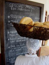 A local lady carrying bread on her head at Che Che Vule, Zanzibar, Tanzania