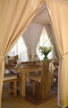 An elegant table setting in the dining area at Naibor Camp, Masai Mara National Reserve, Kenya