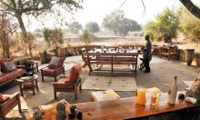 Outdoor dining and lounge deck at Mwamba Bush Camp, South Luangwa National Park, Zambia