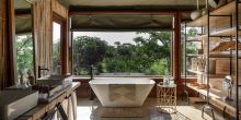 Bathroom with a view at Faru Faru River Lodge, Grumeti Private Reserve, Tanzania