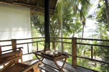 The quiet veranda with beautiful views of the palms at Pole Pole Bungalow Resort, Mafia Island, Tanzania